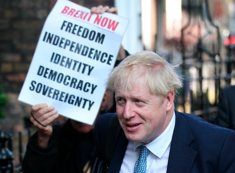 Conservative party leadership contender Boris Johnson, is shadowed by a Brexit demonstrator, as he arrives at his office in central London on the day of the UK leadership announcement. PA via AP