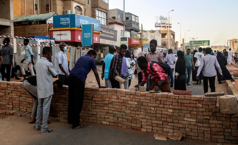 Demonstrators build a barricade on a street in the capital Khartoum during an anti-coup protest. EPA