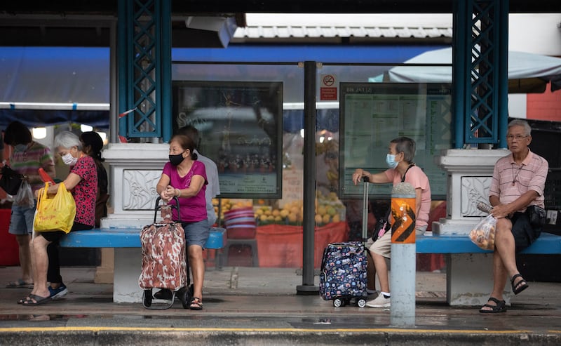 People wait for a bus in Singapore, where about one in four citizens will be aged 65 and above by 2030. EPA