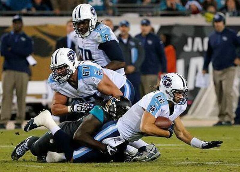 Tennessee Titans quarterback Charlie Whitehurst, right, is sacked by Jacksonville Jaguars' Sen'Derrick Marks on the final play of an NFL football game, Thursday, Dec. 18, 2014, in Jacksonville, Fla. Jacksonville won 21-13. (AP Photo/Stephen B. Morton)




