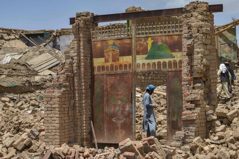 An Afghan man stands in a house damaged by an earthquake in Bernal district, Paktika province. Rescuers battled through heavy rain to reach cut-off areas in eastern Afghanistan after a powerful earthquake killed at least 1,000 people. AFP