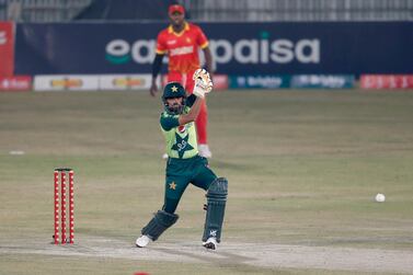 Pakistani batsman Babar Azam, in green, plays a shot for boundary during the 1st Twenty20 cricket match against Zimbabwe at the Pindi Cricket Stadium, in Rawalpindi, Pakistan, Saturday, Nov. 7, 2020. (AP Photo/Anjum Naveed)