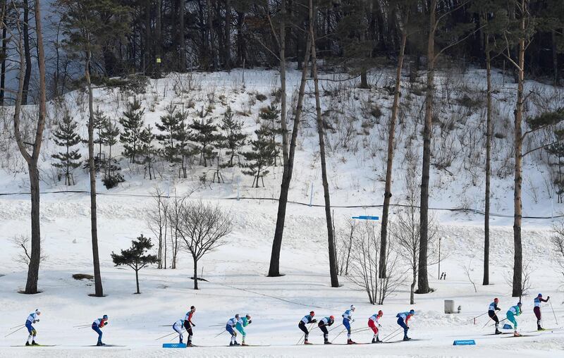 Athletes compete in the men's 50km mass start classic cross-country skiing at the 2018 Winter Olympics. Toby Melville / Reuters