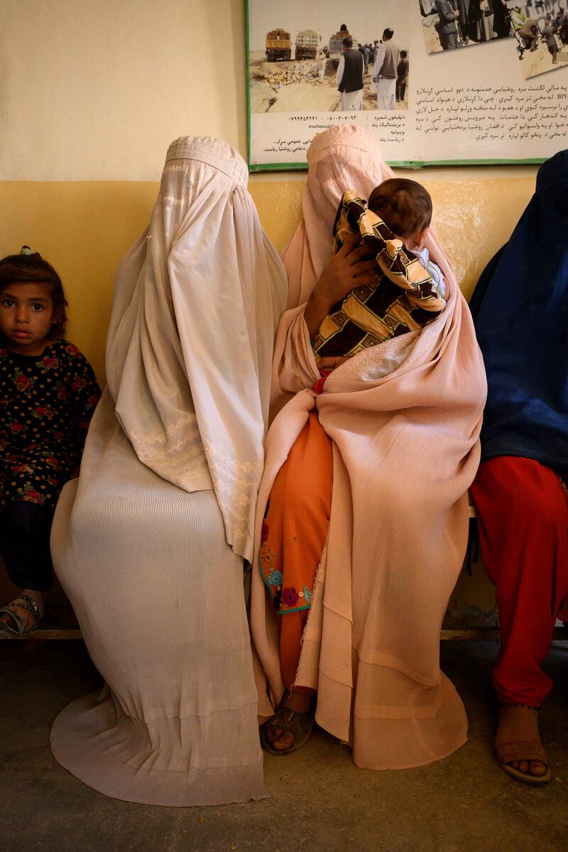 Women wait with their children. It is feared maternity services will be devastated if the Taliban takes control.
