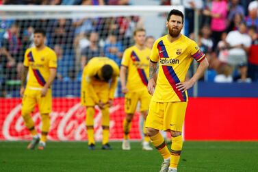 Barcelona's Lionel Messi look on after Levante's Nemanja Radoja scores their third goal on Saturday. Reuters