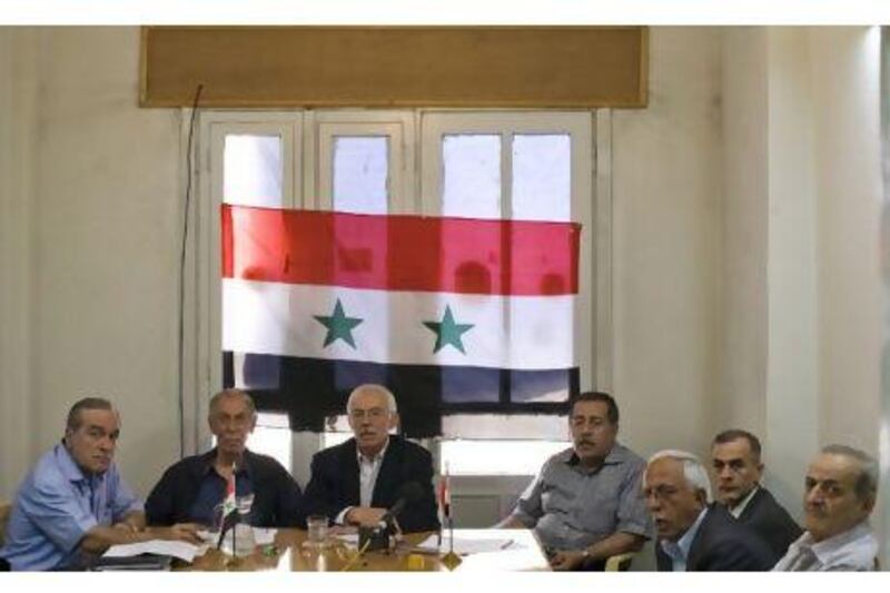 Leading Syrian dissidents, including Hussein al Oudat, left, Hasan Abdul Azeem, third from left, and Aref Dalila, far right, launch the National Coordination Committee in Damascus yesterday. Phil Sands/The National