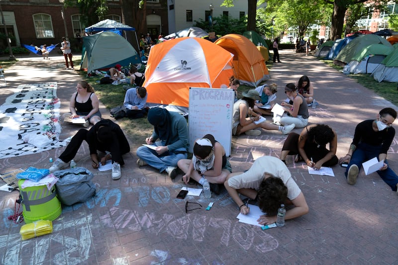 Students write letters in support of Palestinians in Gaza at an encampment at George Washington University, in Washington. AP