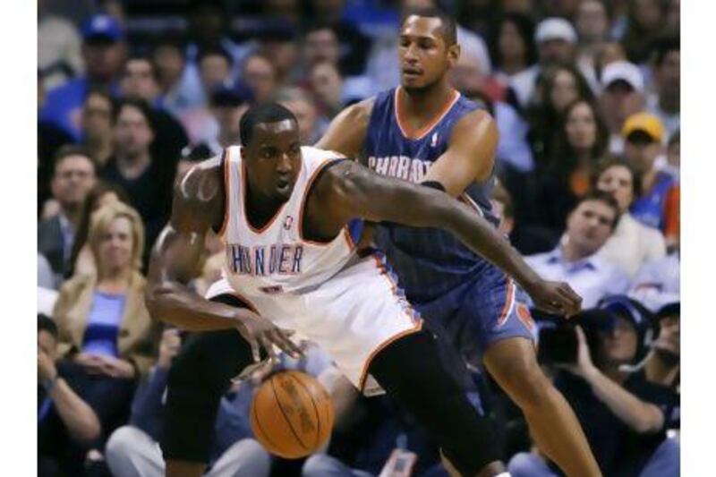 Oklahoma City Thunder center Kendrick Perkins, front, drives to the basket against Charlotte Bobcats in their last game on Friday. Alonzo Adams / AP Photo