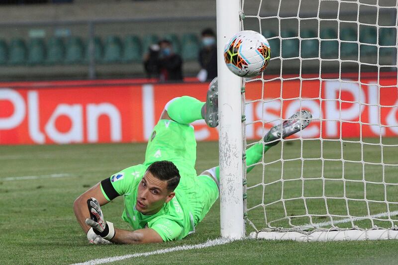Verona goalkeeper Marco Silvestri makes a diving save. AP Photo