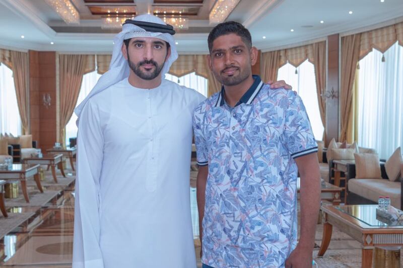 Sheikh Hamdan with Abdul Ghafoor Abdul Hakim. Mr Hakim, who is from Pakistan, said he was only carrying out his duty to protect fellow road users. Photo: Sheikh Hamdan / Twitter