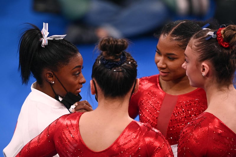 USA's Simone Biles talks to teammates during the artistic gymnastics women's team final.