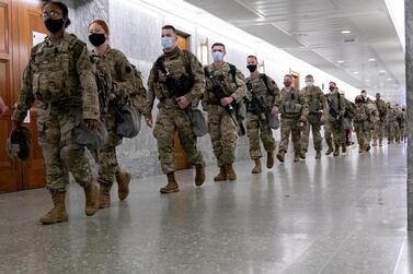 Members of the National Guard walk through Dirksen Senate Office Building in Washington on March 4, 2021. Bloomberg