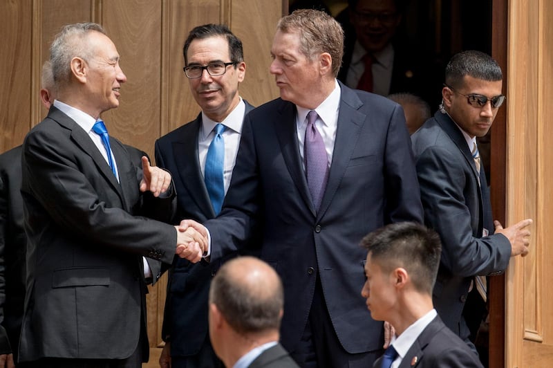 Treasury Secretary Steve Mnuchin, center, and United States Trade Representative Robert Lighthizer, third from left, and Chinese Vice Premier Liu He, left, speak together as Liu He departs the Office of the United States Trade Representative in Washington, Friday, May 10, 2019. (AP Photo/Andrew Harnik)