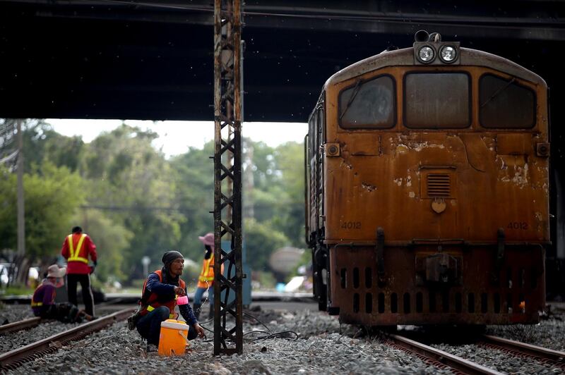 epa07698874 Laborers work on a train track in Bangkok, Thailand, 06 July 2019. The State Railway of Thailand (SRT) plans to spend an estimated 90 billion baht (2.6 billion euro) to upgrade existing single-track train lines to new dual-track lines between Bangkok, Huahin, Chumphon, and the deep south according to local media. The project, which is expected to be completed in 2022, hopes to increase business and tourism as it will considerably reduce travel times.  EPA/DIEGO AZUBEL