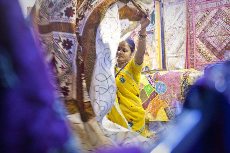 Seema Ganesh Lal, a saleswoman from India stands at her stall at the India pavilion of Global Village. She sells rugs from Gujurat and other Indian states. Razan Alzayani / The National