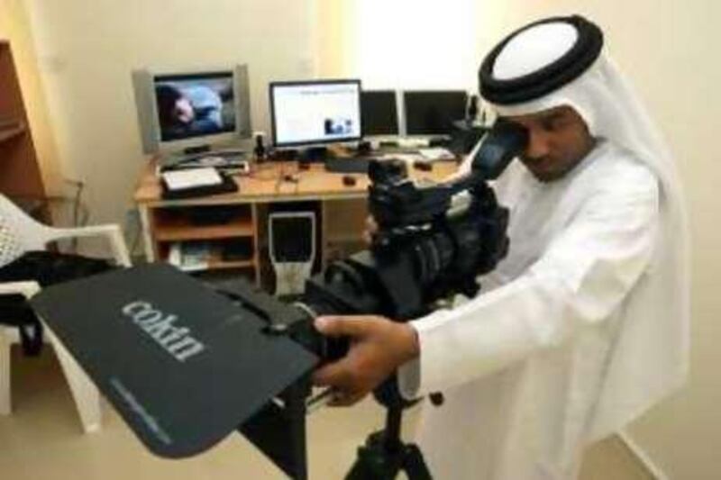 Ras Al Khaimah, 1st July 2008.  Waleed Al Shehhi (film director)checking out the camera,  at his special editing room, in his studio.  (Jeffrey E. Biteng / The National)  Editors Note; For Arts & Life.  The newly renovated home studio of Waleed is slowly bringing in his equipments and materials.  For now I have to contend myself with the available materials in his present film studio. *** Local Caption ***  JB0408-Waleed.jpg