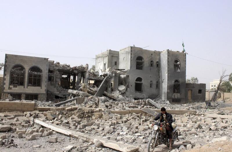 A man rides a motorcycle past the headquarters of the Houthi rebel group in Saada city, north-west Yemen, that was destroyed in an airstrike by a Saudi-led coalition. Reuters / April 26, 2015