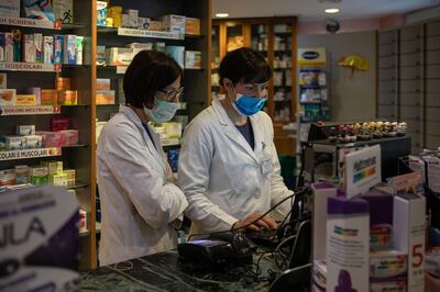 MILAN, ITALY - MARCH 11: Pharmacists at work on March 11, 2020 in Milan, Italy. The Italian Government has strengthened up its quarantine rules, shutting all commercial activities except for pharmacies, food shops, gas stations, tobacco stores and news kiosks in a bid to stop the spread of the novel coronavirus. (Photo by Emanuele Cremaschi/Getty Images)