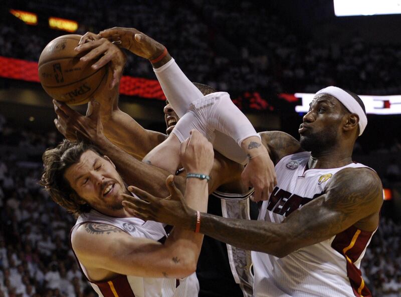 Mike Miller (L) and LeBron James (R) of the Miami Heat vie for a rebound with Tim Duncan (C) of the San Antonio Spurs during the first half in Game 6 of the NBA Finals at the American Airlines Arena June 19, 2013 in Miami, Florida. TOPSHOTS AFP PHOTO / Brendan SMIALOWSKI
 *** Local Caption ***  375733-01-08.jpg