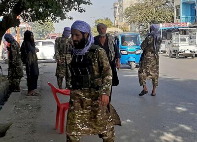Taliban fighters stand guard at a checkpoint in Kunduz city, northern Afghanistan, Monday, Aug.  9, 2021.  AP