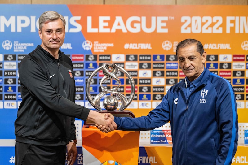Urawa Reds Diamonds head coach Maciej Skorza, left, and Al Hilal manager Ramon Diaz shake hands in front of the Asian Champions League tropy ahead of the final second leg in Saitama, Japan. AFP