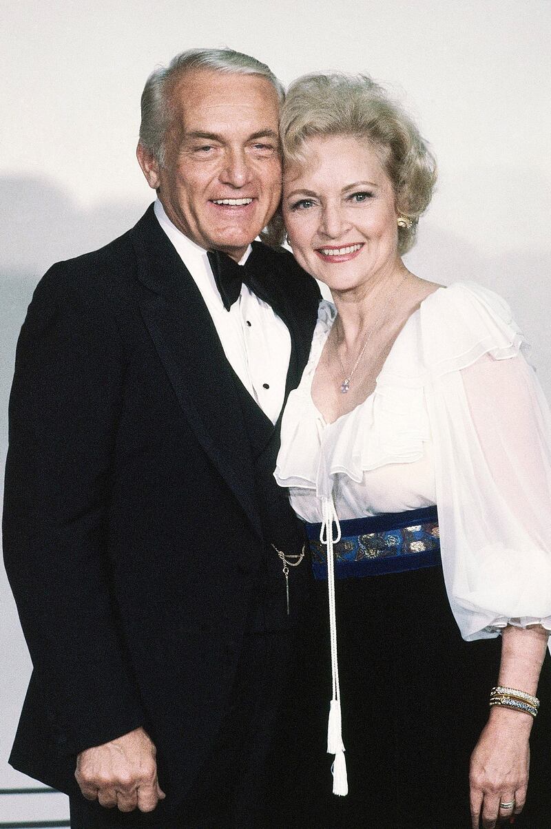 Betty White, in a white layered top, black skirt and embroidered blue belt, with Ted Knight at the Emmy Awards in Los Angeles on September 13, 1981.  AP