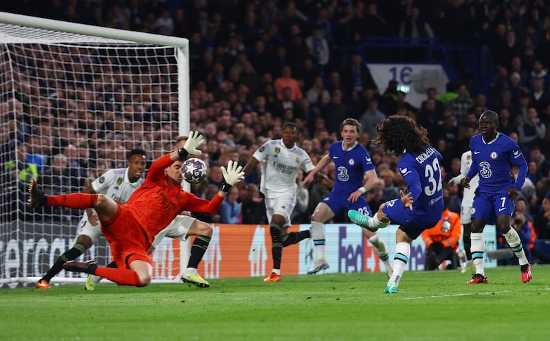 Real Madrid goalkeeper Thibaut Courtois saves from Chelsea's Marc Cucurella. Reuters