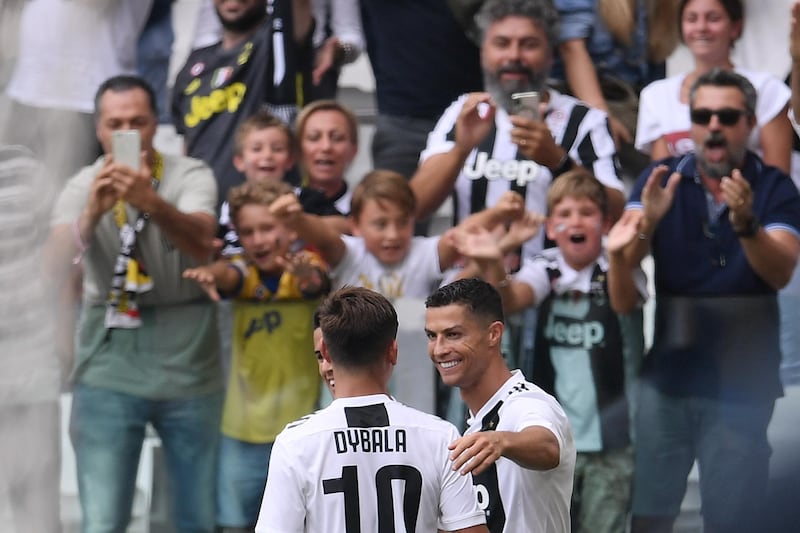 Ronaldo celebrates with Paulo Dybala. AFP