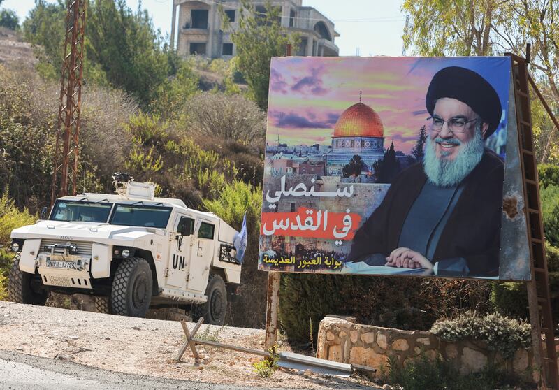 A UN peacekeepers vehicle drives near a picture showing Lebanon's Hezbollah leader Hassan Nasrallah in Adaisseh village, near the Lebanese-Israeli border, in southern Lebanon. Reuters