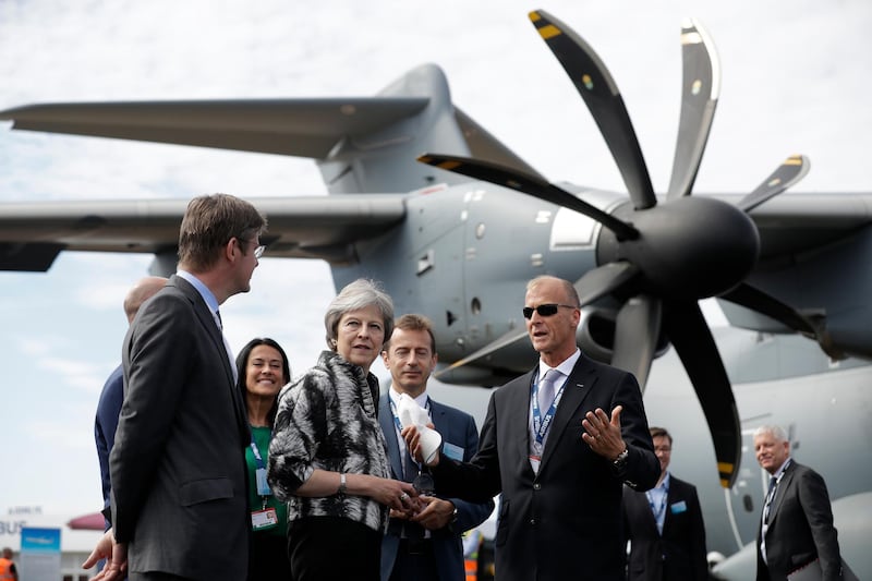 British Prime Minister Theresa May, second left, speaks with Airbus chief Tom Enders next to an Airbus A400M Atlas military transport aircraft at the Farnborough Airshow. AP Photo