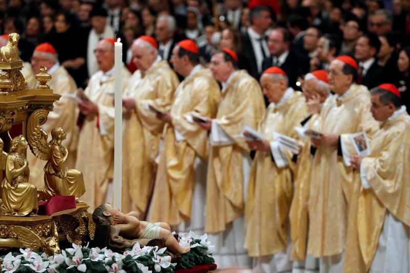 Cardinals attend the Christmas Eve mass led by Pope Francis in St Peter's Basilica at the Vatican. AP