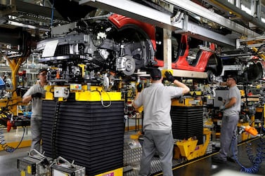 Workers on a production line at Nissan's car plant in Sunderland Britain. UK car manufacturing fell 29.3% to 920,928 vehicles last year compared with 2019. Reuters