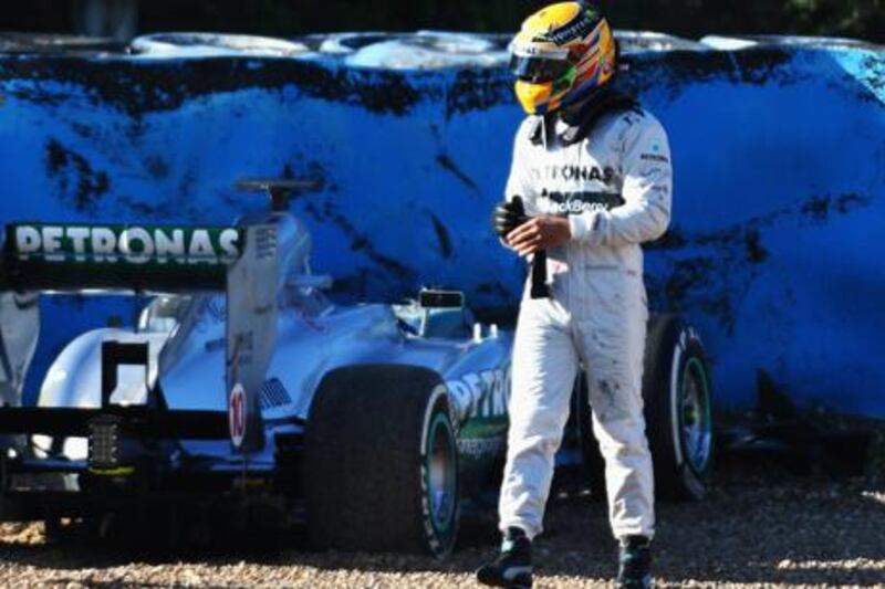 Lewis Hamilton walks away from his new Mercedes GP car after crashing into a tire wall during his first day's testing in Jerez.