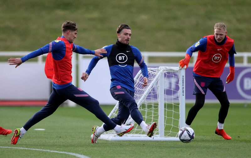 England's Jack Grealish is chalenged by John Stones. Reuters