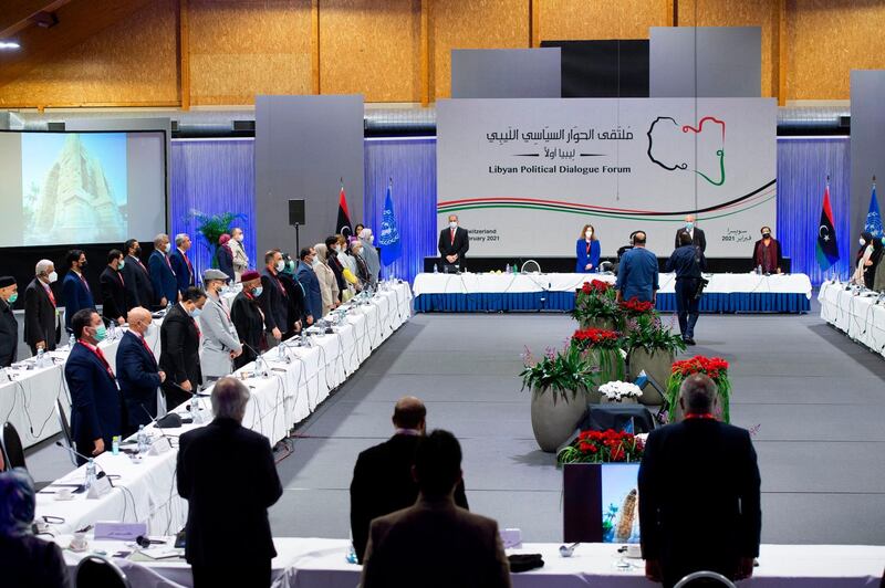 Delegates stand during the national anthem at the opening of the Libyan Political Dialogue Forum at an undisclosed location near Geneva, Switzerland, to choose a new temporary executive to lead the country through a transition until elections scheduled for December. AFP