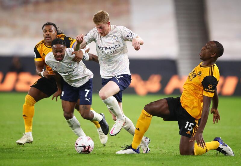 Manchester City's Kevin De Bruyne and Raheem Sterling in action with Wolverhampton Wanderers' Adama Traore and Willy Boly. Reuters