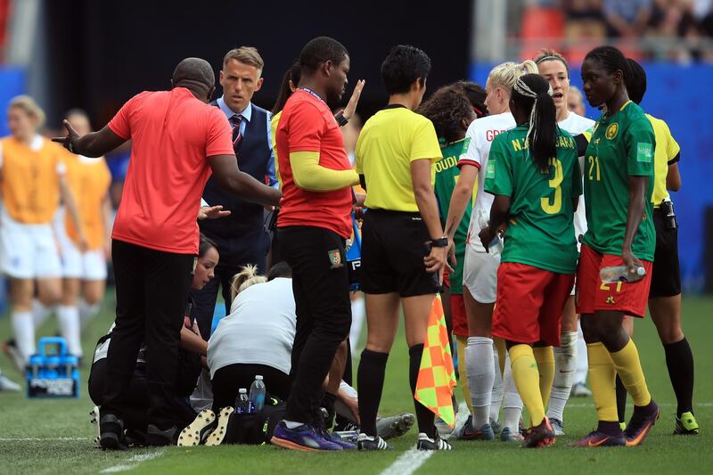 VALENCIENNES, FRANCE - JUNE 23: England Head Coach Phil Neville looks on as Cameroon Head Coach Alain Djeumfa reacts toward him late in the game during the 2019 FIFA Women's World Cup France Round Of 16 match between England and Cameroon at Stade du Hainaut on June 23, 2019 in Valenciennes, France. (Photo by Marc Atkins/Getty Images)