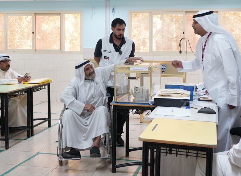 A man votes during parliamentary elections at a polling station in Kuwait City. Reuters