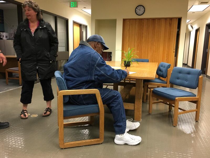 Former football legend O.J. Simpson signs documents at the Lovelock Correctional Center, Saturday, Sept. 30, 2017, in Lovelock, Nev. Simpson was released from the Lovelock Correctional Center in northern Nevada early Sunday, Oct. 1, 2017. (Brooke Keast/Nevada Department of Corrections via AP)