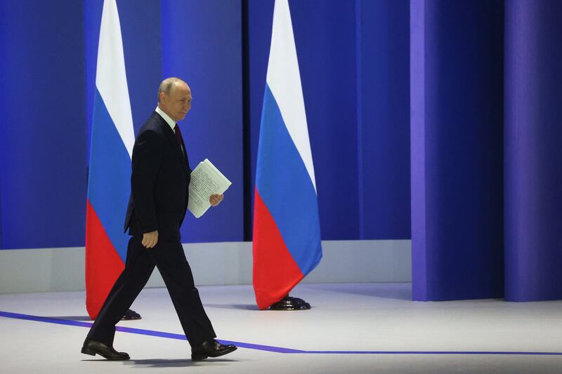 Mr Putin strides on to the stage. Reuters