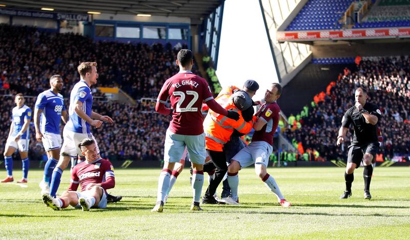 A fan invades the pitch and attacks Aston Villa midfielder Jack Grealish during the match at St Andrews. Reuters