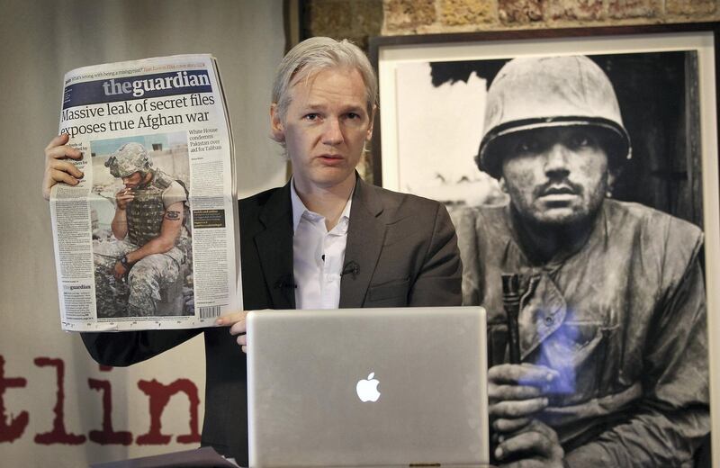 LONDON, ENGLAND - JULY 26:  Julian Assange of the WikiLeaks website holds up a copy of The Guardian newspaper as he speaks to reporters in front of a Don McCullin Vietnam war photograph at The Front Line Club on July 26, 2010 in London, England. The WikiLeaks website has published 90,000 secret US Military records. The Guardian and The New York Times newspapers and the German Magazine Der Spiegel have also published details today.  (Photo by Peter Macdiarmid/Getty Images)