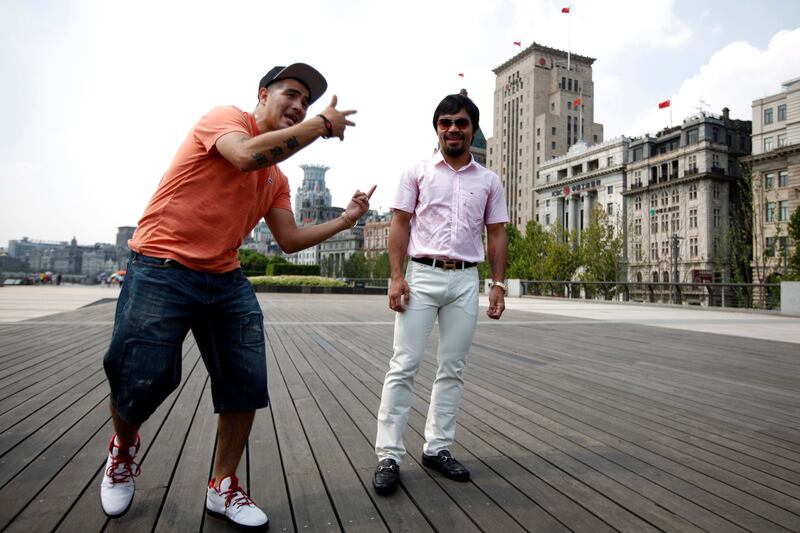 Filipino boxer Manny Pacquiao (R) and Brandon Rios of the U.S. pose before a news conference at The Bund in Shanghai July 31, 2013. Pacquiao will challenge Rios in a welterweight boxing match in Macau on November 24. REUTERS/Aly Song (CHINA - Tags: SPORT BOXING) *** Local Caption ***  SHA105_BOXING-_0731_11.JPG