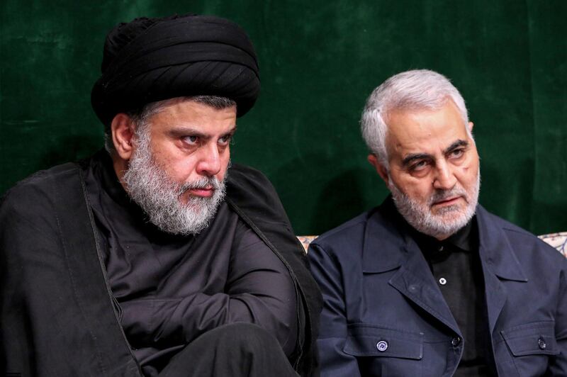 A handout picture provided by the office of Iran's Supreme Leader Ayatollah Ali Khamenei on September 10, 2019 shows Iraqi Shiite cleric, politician, and militia leader Muqtada al-Sadr (L) sitting alongside Qasem Soleimani, Iranian Revolutionary Guards Corps (IRGC) Major General and commander of the Quds Force, during a ceremony commemorating Ashura in the capital Tehran. - Ashura is commemorated by Shiite Muslims worldwide and marks the climax of mourning rituals in the Islamic month of Muharram for the 7th century killing of Imam Hussein, the grandson of Prophet Mohammed, in the Battle of Karbala in 680 AD. (Photo by - / KHAMENEI.IR / AFP) / === RESTRICTED TO EDITORIAL USE - MANDATORY CREDIT "AFP PHOTO / HO / KHAMENEI.IR" - NO MARKETING NO ADVERTISING CAMPAIGNS - DISTRIBUTED AS A SERVICE TO CLIENTS ===