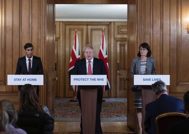 UK Prime Minister Boris Johnson, centre, speaks while Chancellor of the Exchequer Rishi Sunak, left, and deputy chief medical officer Jenny Harries, right, listen during a daily coronavirus briefing at 10 Downing Street, on March 20, 2020. Bloomberg