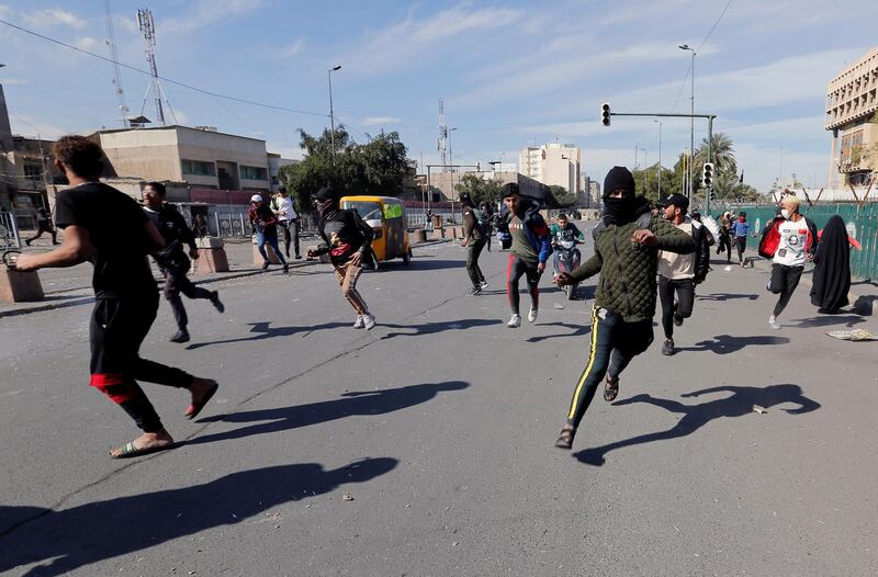 Iraqi demonstrators run away from security forces during the ongoing anti-government protests in Baghdad. REUTERS