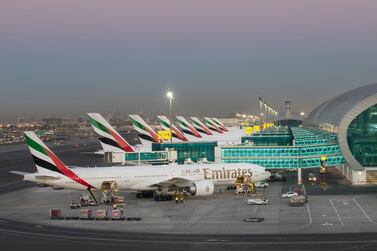 Emirates aircraft await departure from Dubai International Airport. Airlines recorded losses of $126.4 billion in 2020 Dubai Airports