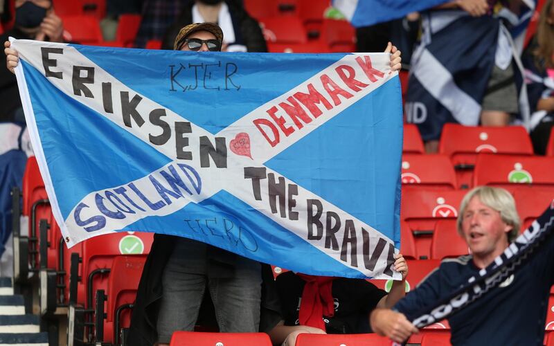 A supporter of Scotland shows a message in support of Danish national soccer player Christian Eriksen before the Euro 2020 Group D match against Czech Republic in Glasgow, Britain, 14 June 2021. EPA