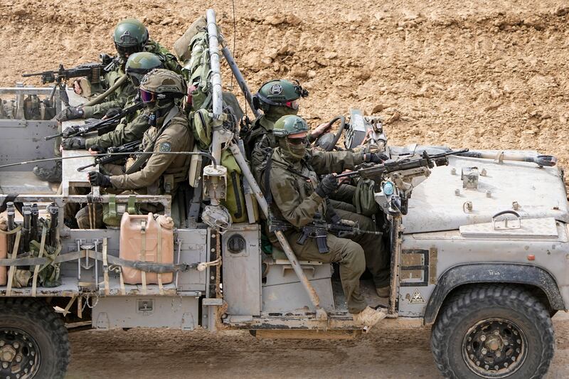 Israeli soldiers drive towards the Gaza Strip, in southern Israel. AP