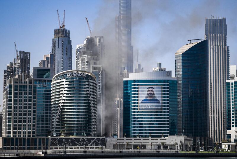 Smoke rises from a fire in a tower in the Business Bay area of Dubai. Karim Sahib / AFP